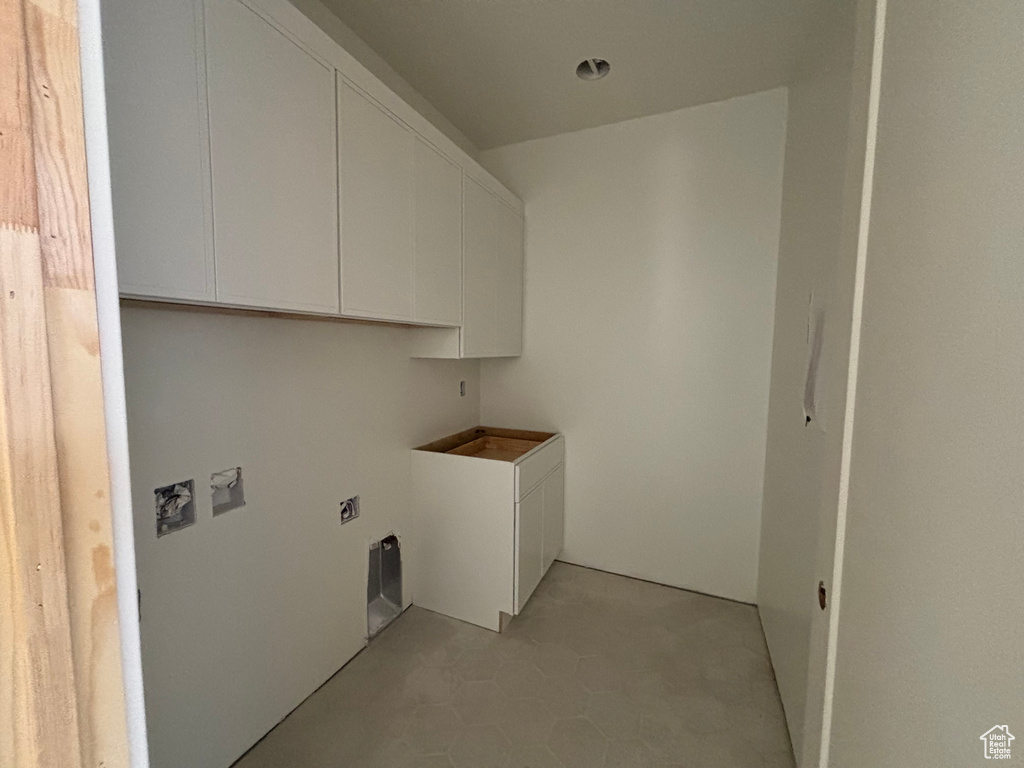 Laundry area featuring cabinet space, hookup for a washing machine, and electric dryer hookup