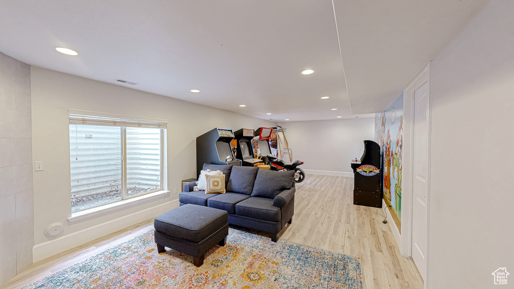 Living room with recessed lighting, visible vents, light wood-style flooring, and baseboards