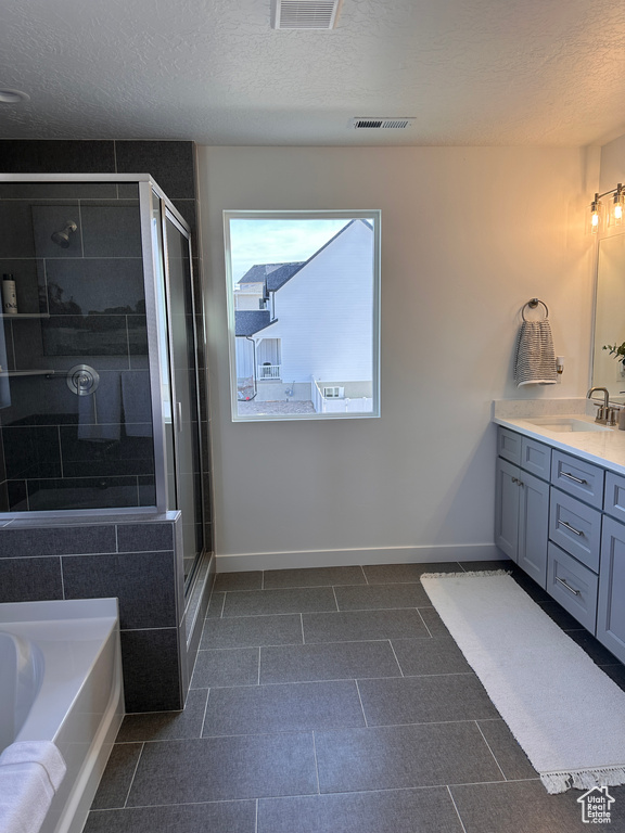 Full bath featuring visible vents, a shower stall, vanity, and baseboards