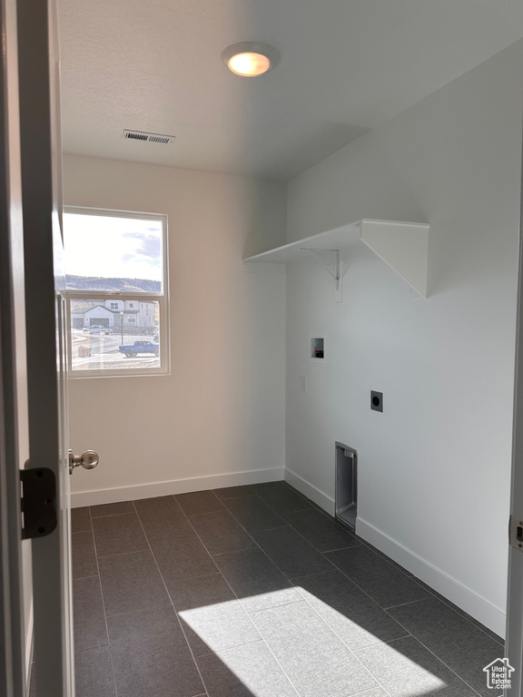 Laundry area with baseboards, visible vents, laundry area, electric dryer hookup, and washer hookup