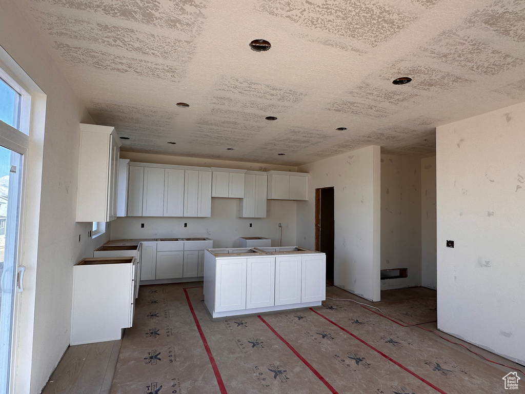 Kitchen with white cabinets and a center island