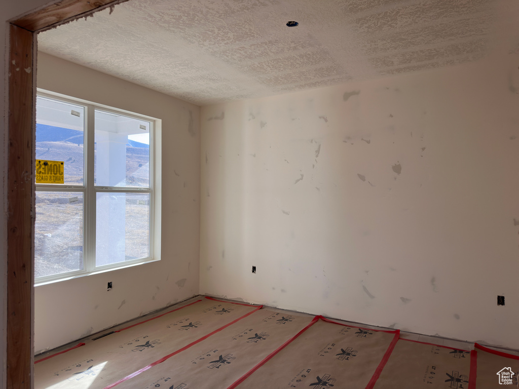 Empty room featuring a textured ceiling