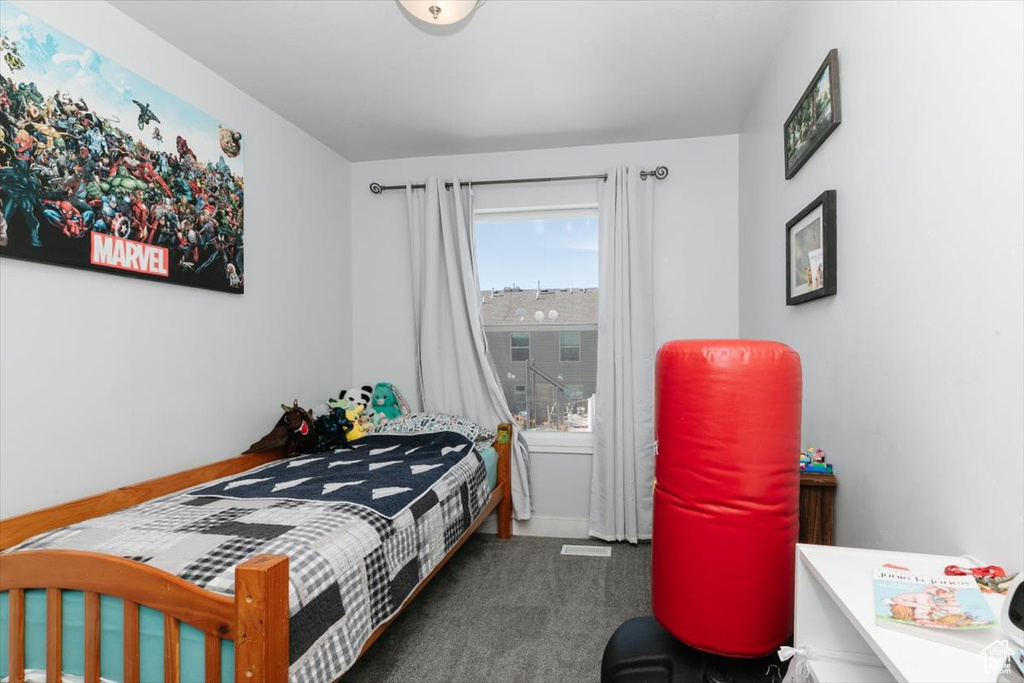 Bedroom with visible vents, baseboards, and carpet