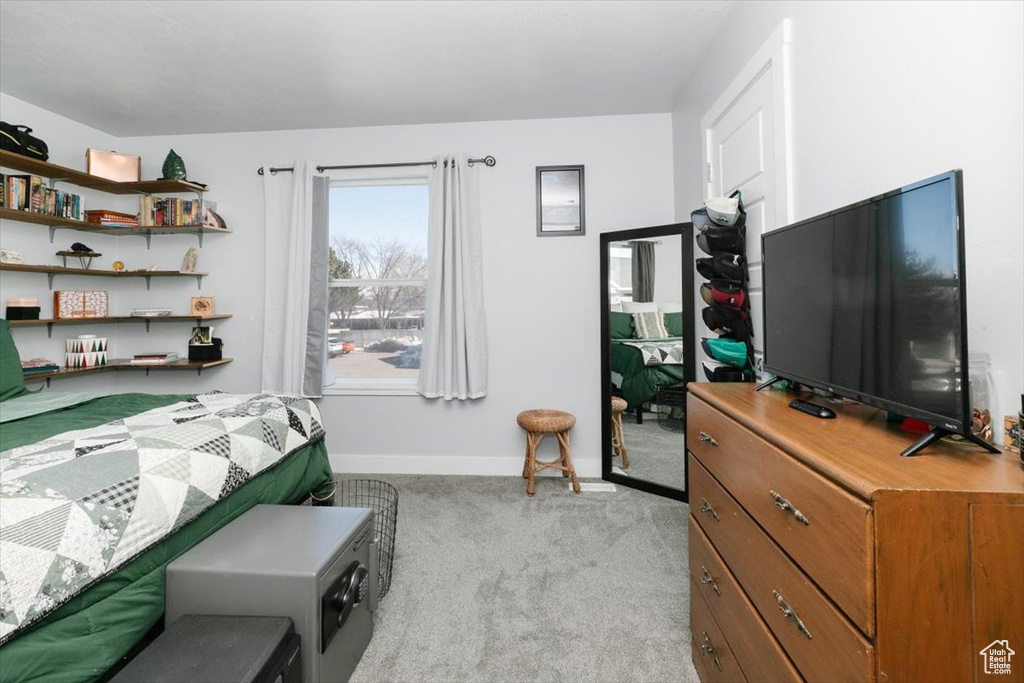 Bedroom with light carpet and baseboards
