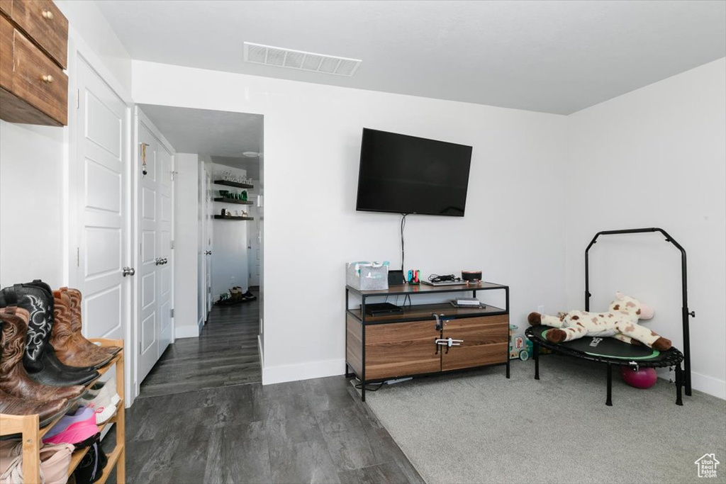 Interior space with wood finished floors, visible vents, and baseboards