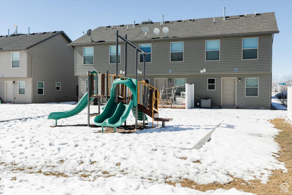 Snow covered playground featuring a playground