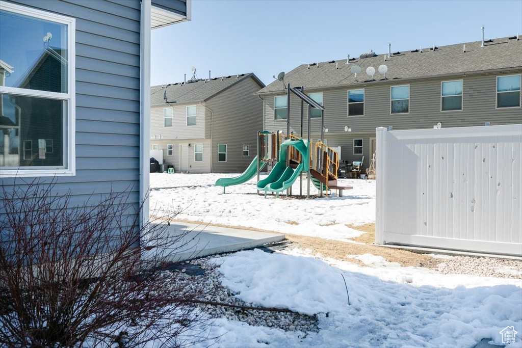 Snow covered playground featuring a playground