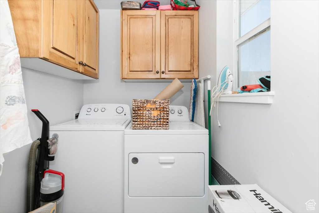 Clothes washing area with cabinet space and washer and clothes dryer