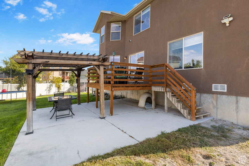 View of patio / terrace with fence, visible vents, a pergola, a deck, and a trampoline