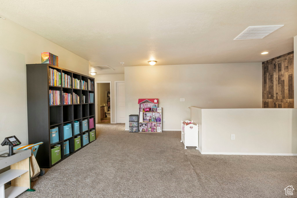 Game room with attic access, visible vents, and carpet floors