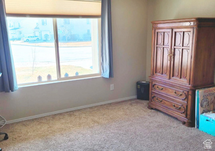 Unfurnished bedroom with carpet and baseboards