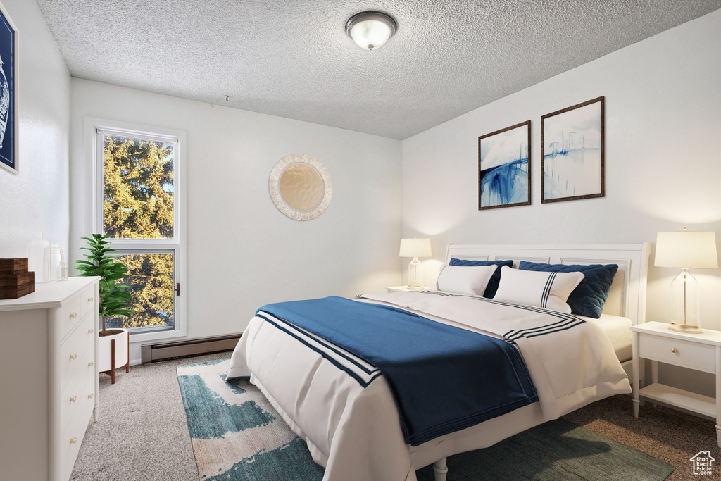 Bedroom featuring carpet, a textured ceiling, and a baseboard radiator