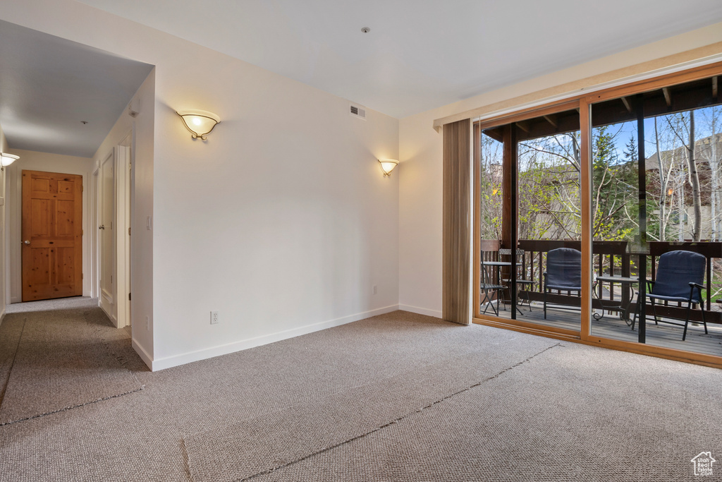 Spare room with carpet floors and baseboards