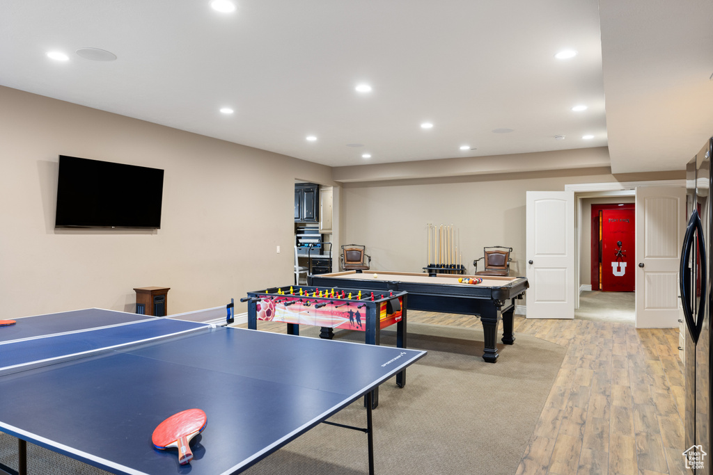 Game room with light wood-style flooring and recessed lighting