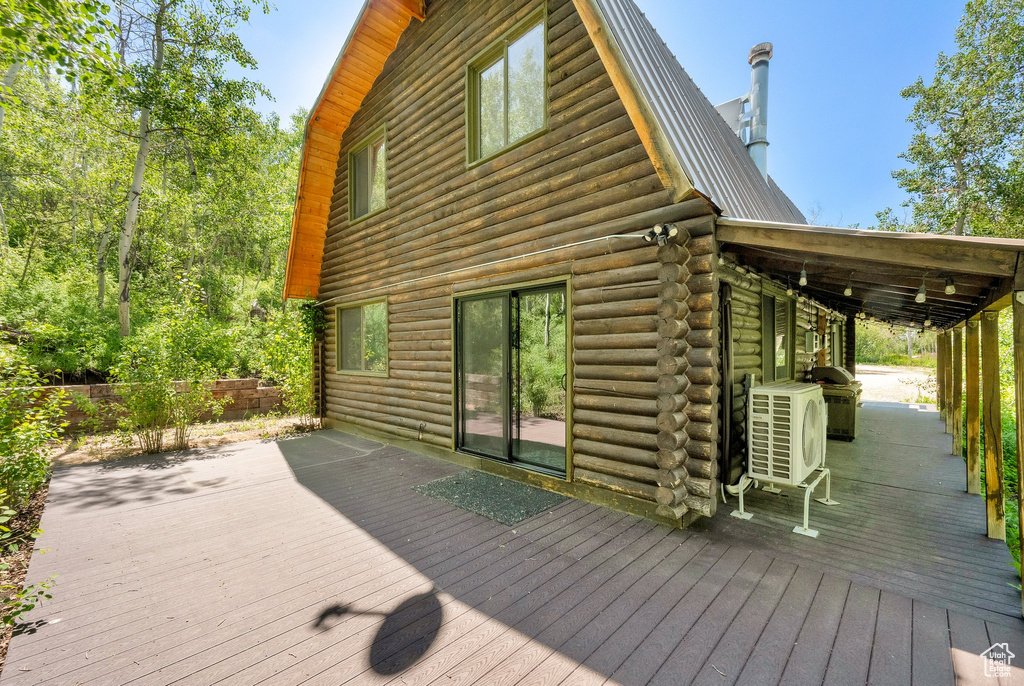 Wooden terrace featuring ac unit