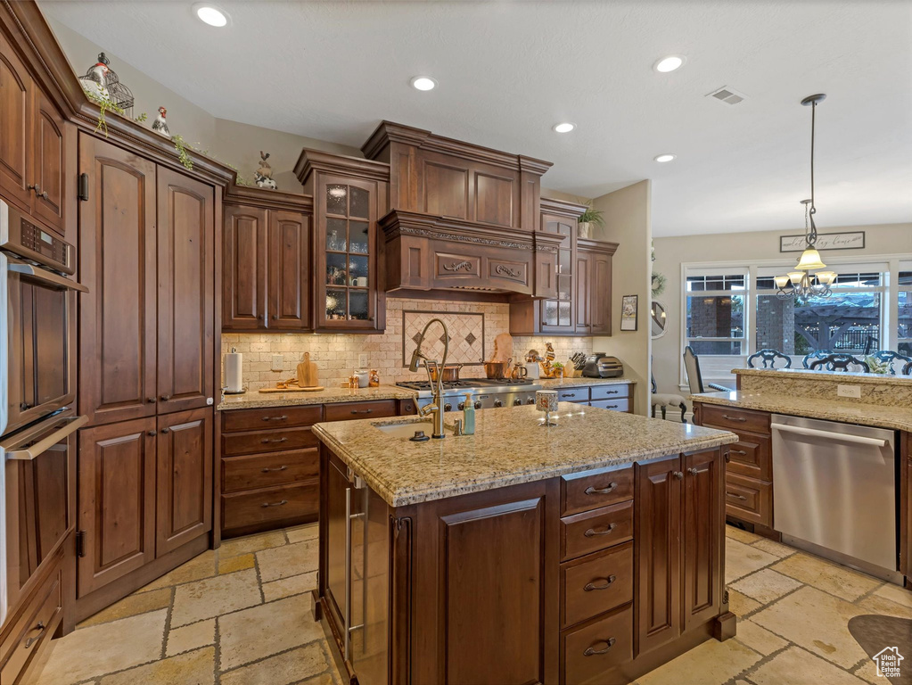 Kitchen with visible vents, glass insert cabinets, recessed lighting, appliances with stainless steel finishes, and stone tile flooring