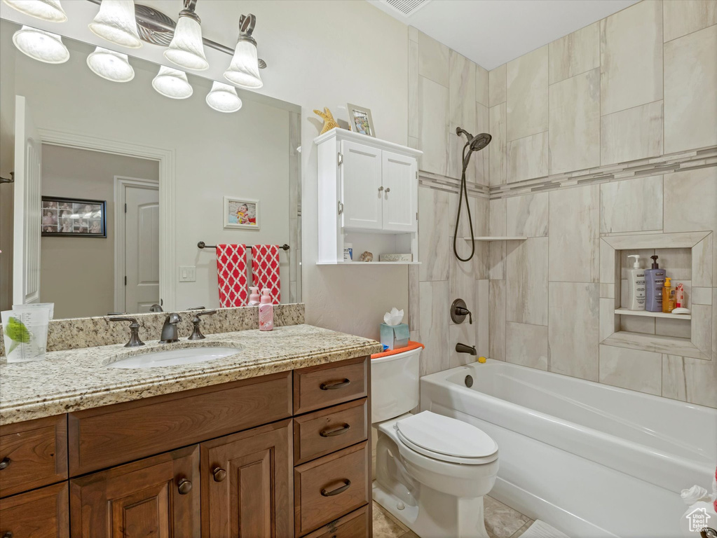 Bathroom featuring vanity, toilet, washtub / shower combination, and visible vents