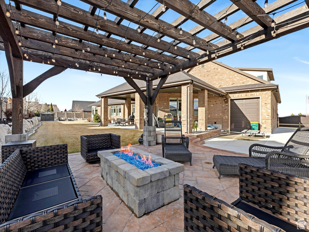 View of patio / terrace featuring an outdoor fire pit and a pergola