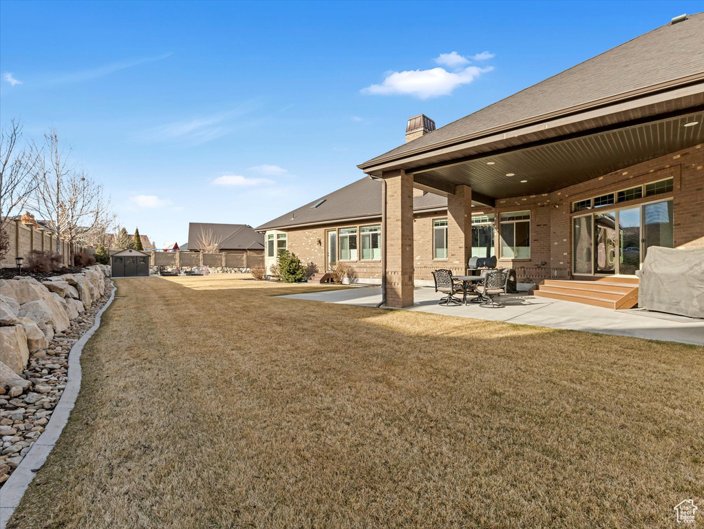 View of yard featuring a patio and fence