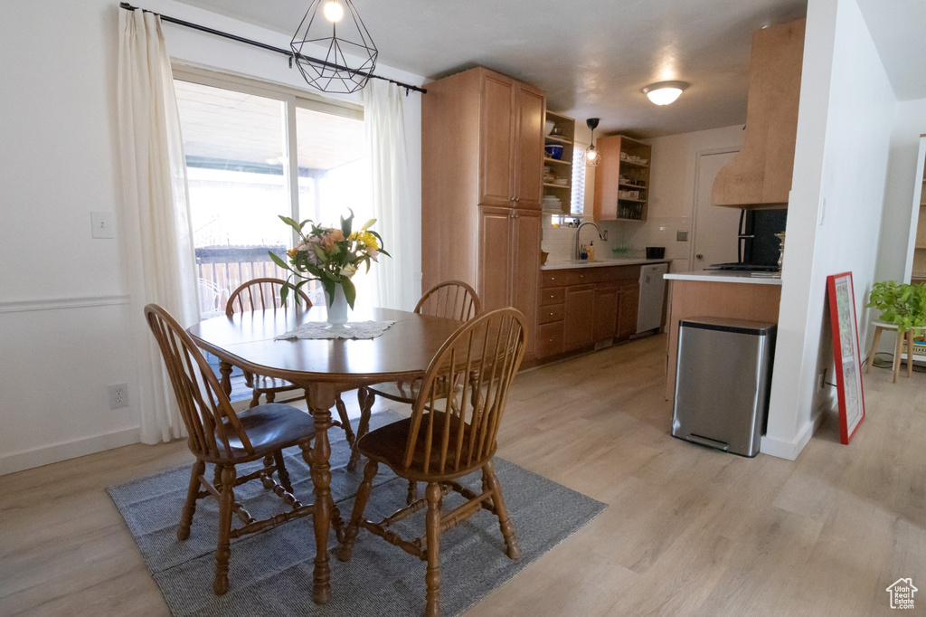 Dining room featuring baseboards and light wood-type flooring