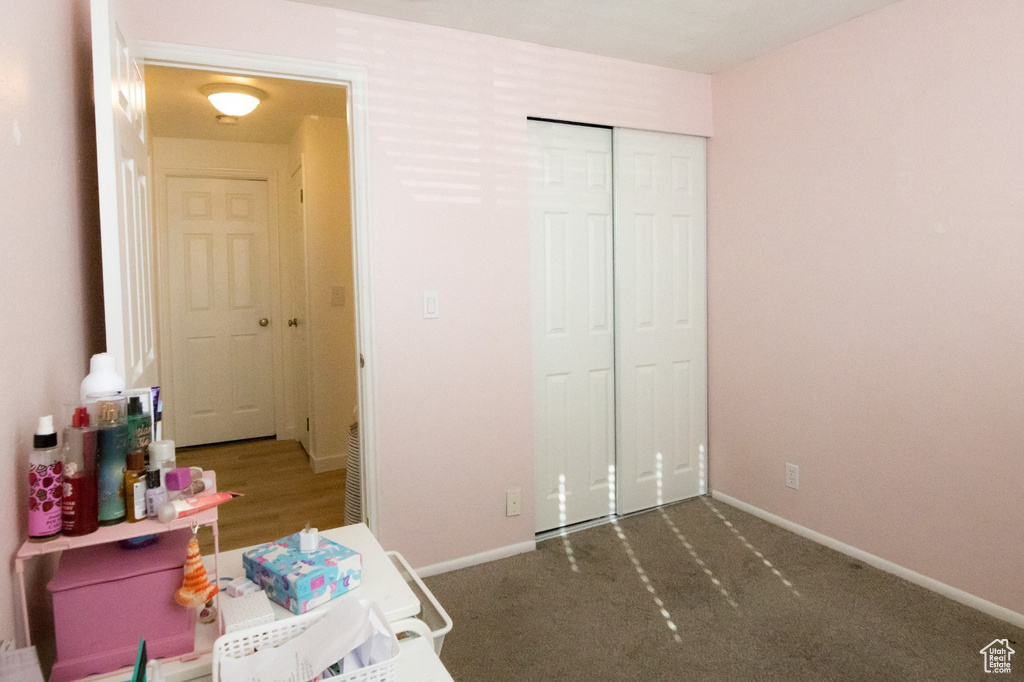 Bedroom featuring a closet, baseboards, and carpet floors