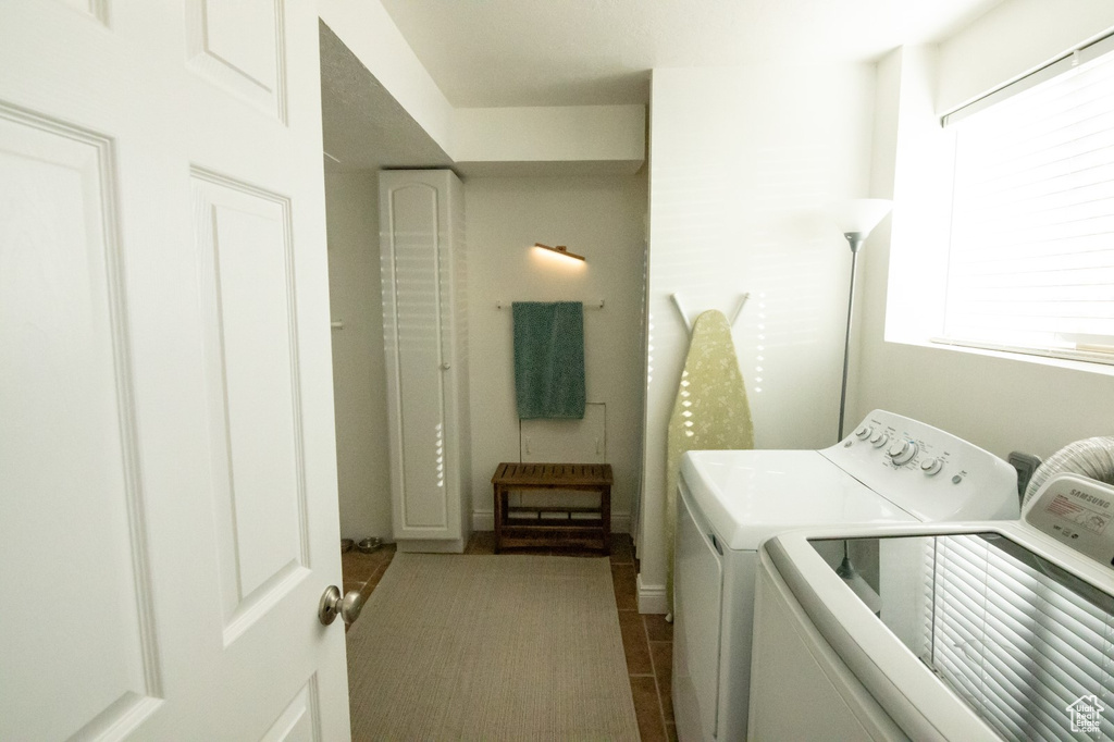 Laundry area featuring tile patterned flooring, laundry area, and separate washer and dryer