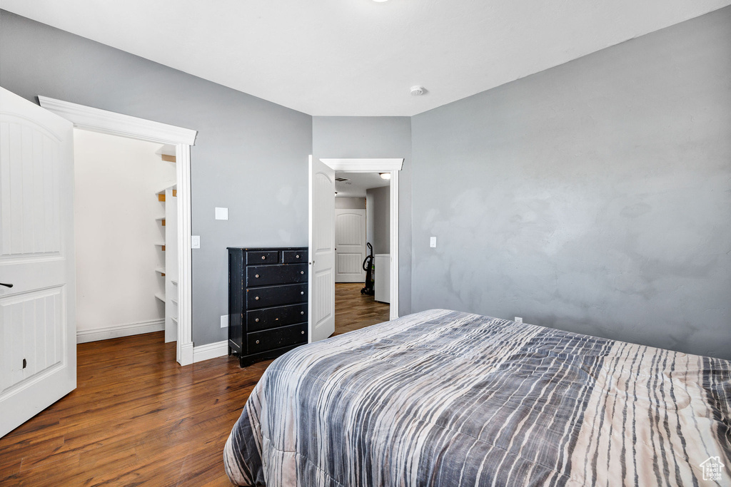 Bedroom featuring baseboards and wood finished floors