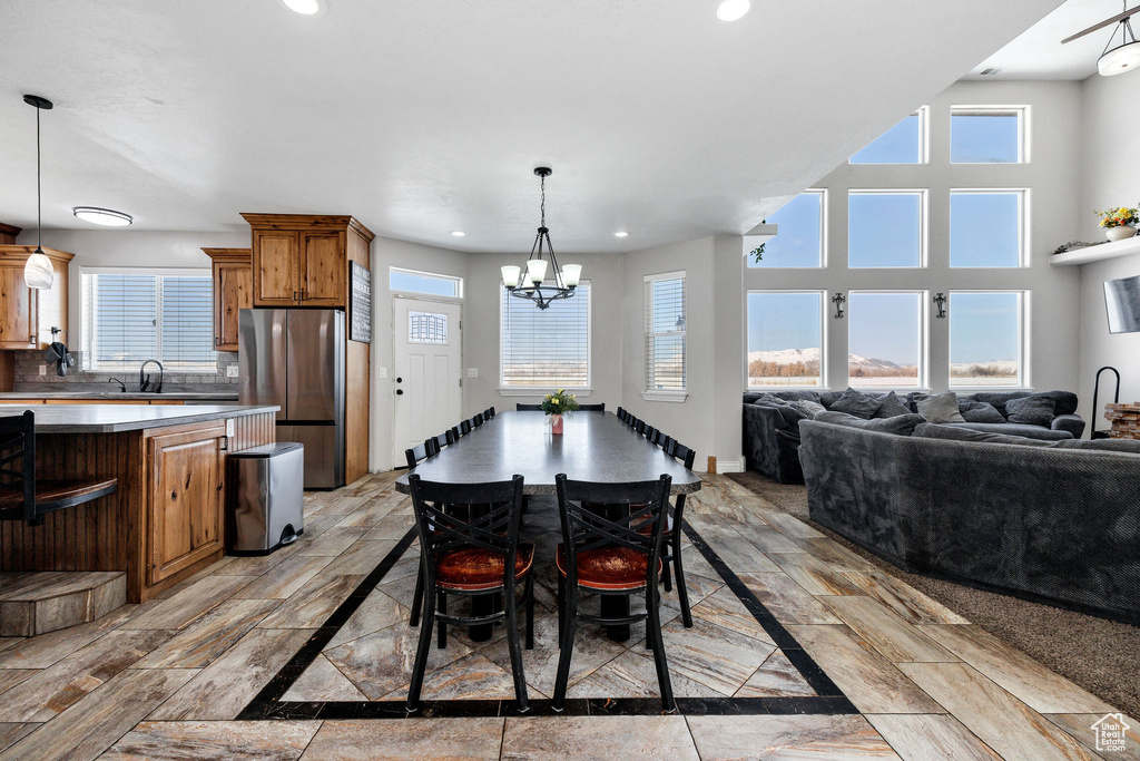 Dining room featuring recessed lighting, an inviting chandelier, and baseboards