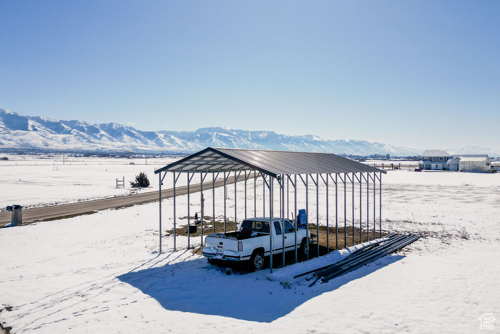 Exterior space with a mountain view and a detached carport