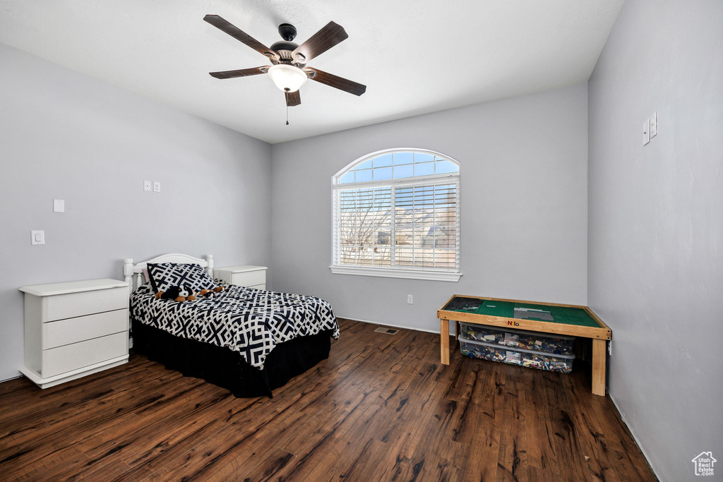 Bedroom featuring ceiling fan and dark wood-style floors