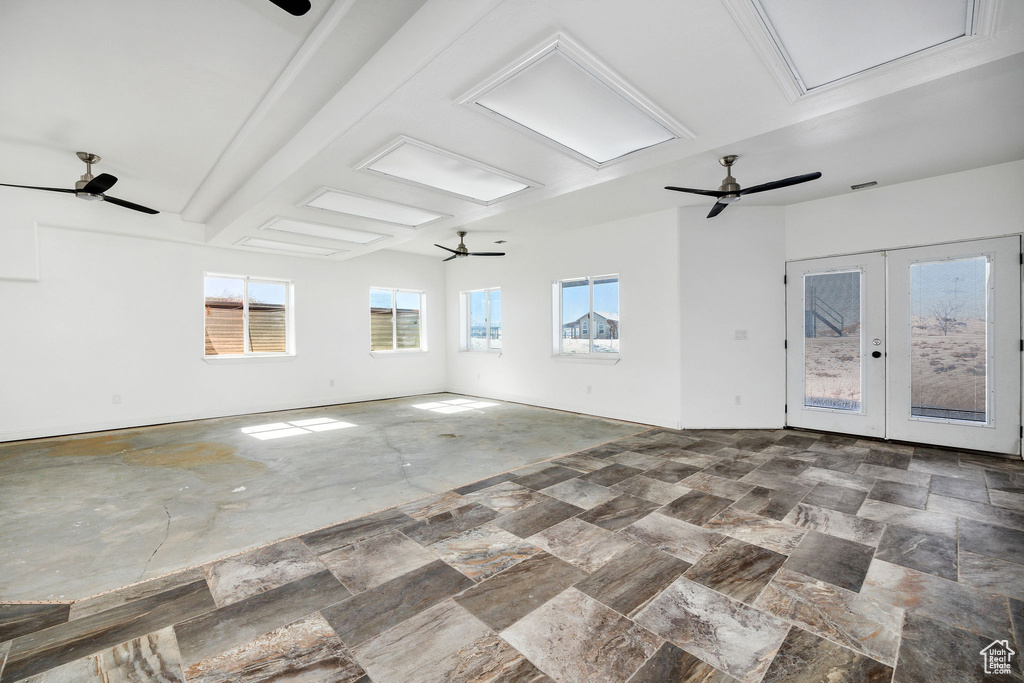 Spare room with visible vents, french doors, attic access, and a ceiling fan