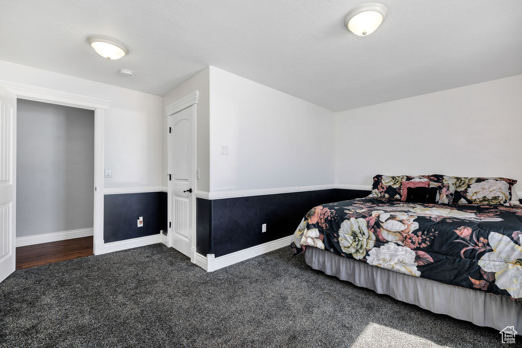 Bedroom with baseboards and carpet floors