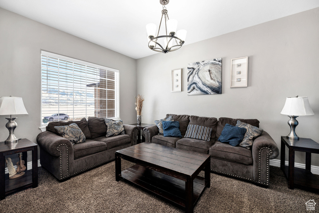 Living area featuring a notable chandelier and baseboards