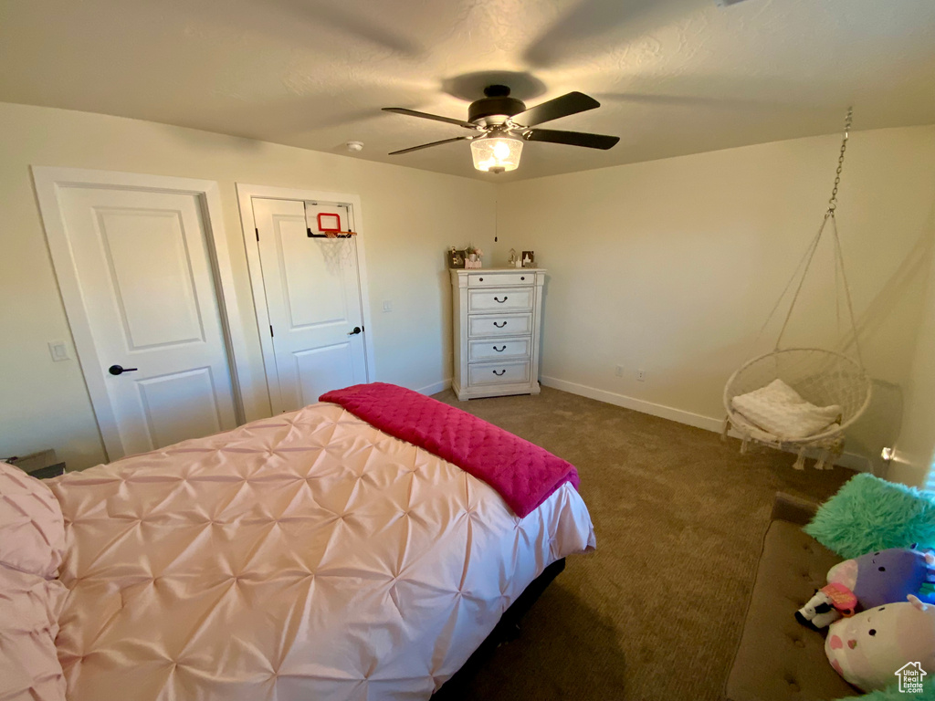 Bedroom with baseboards, carpet, and a ceiling fan