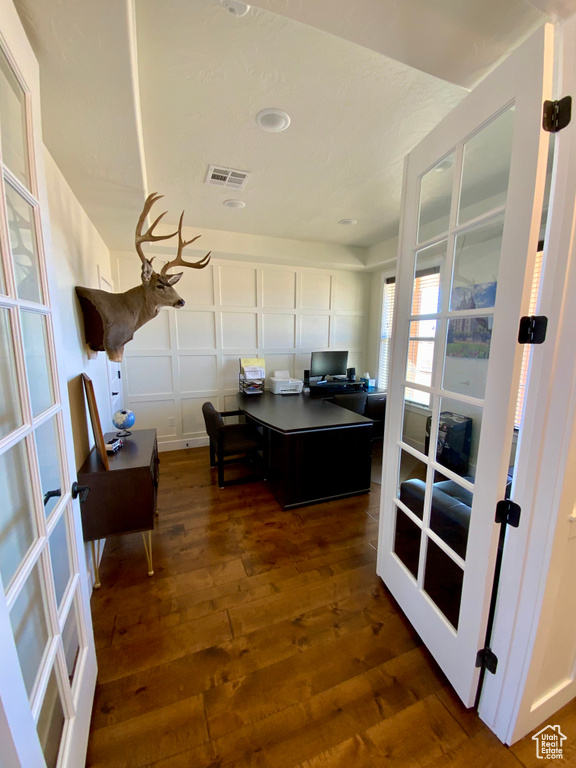 Office space with visible vents, dark wood-style flooring, and french doors