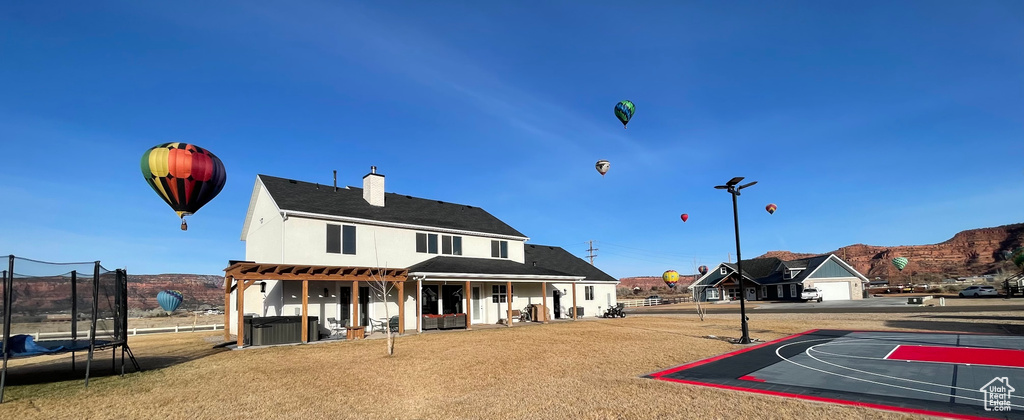 View of basketball court with a mountain view and a trampoline
