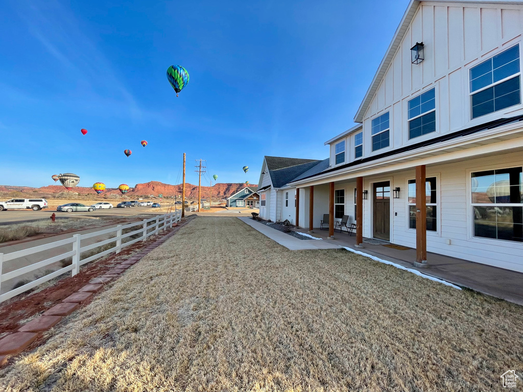 View of yard featuring covered porch and fence