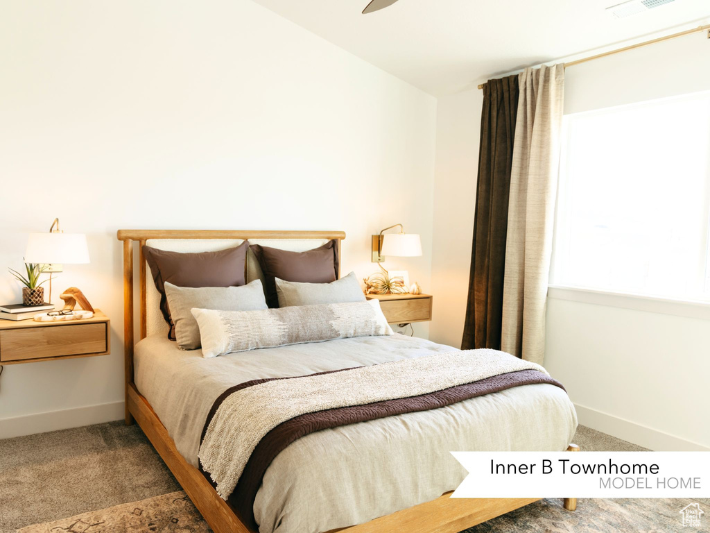 Carpeted bedroom with lofted ceiling and baseboards
