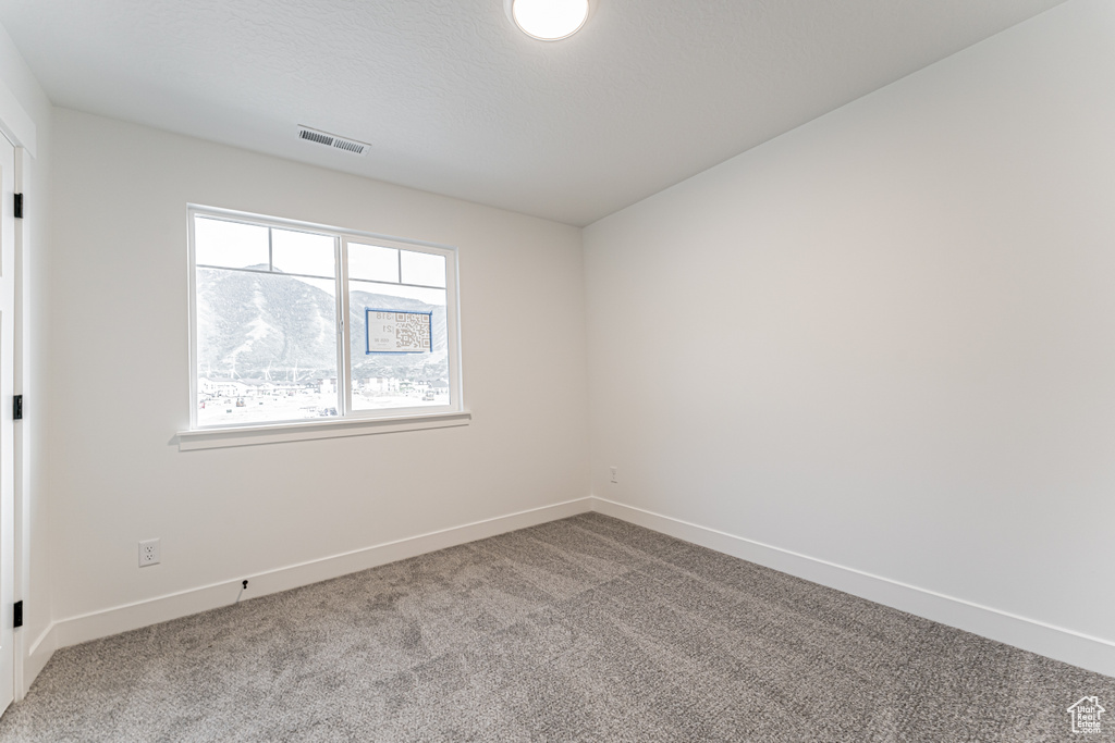 Spare room with carpet floors and baseboards