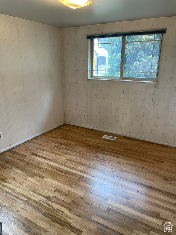 Spare room with wood finished floors