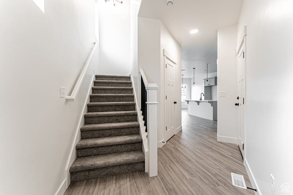 Stairway featuring wood finished floors and baseboards