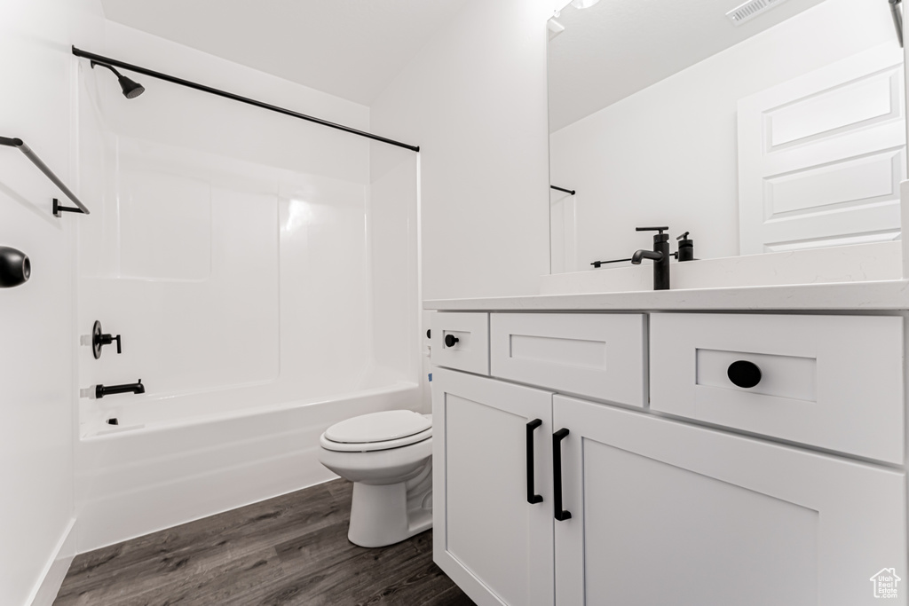 Bathroom with vanity, shower / bathtub combination, and wood finished floors