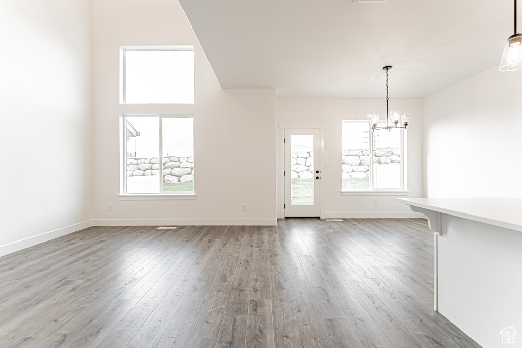 Unfurnished dining area featuring a chandelier and light wood-style flooring