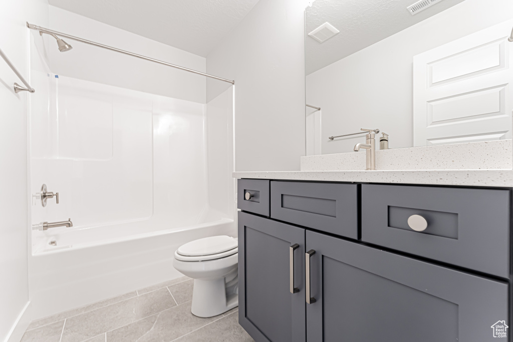 Full bath with vanity, shower / bathtub combination, and tile patterned flooring