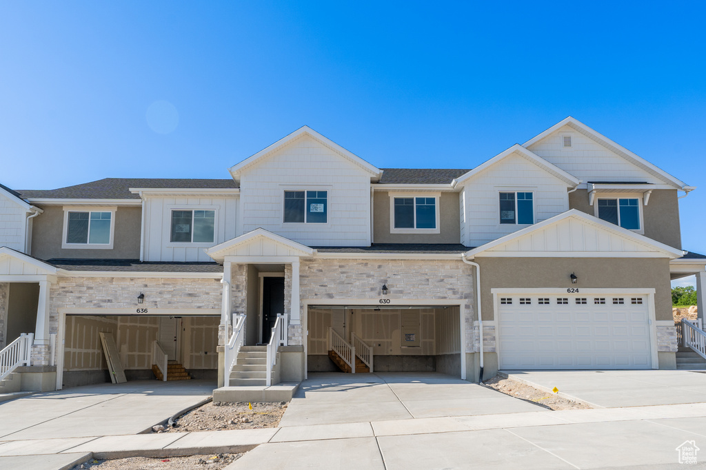 View of front of property with driveway, board and batten siding, and a garage