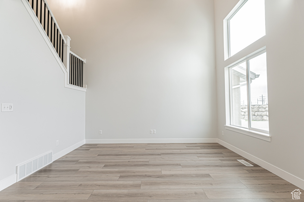 Spare room with healthy amount of natural light and light wood-style flooring