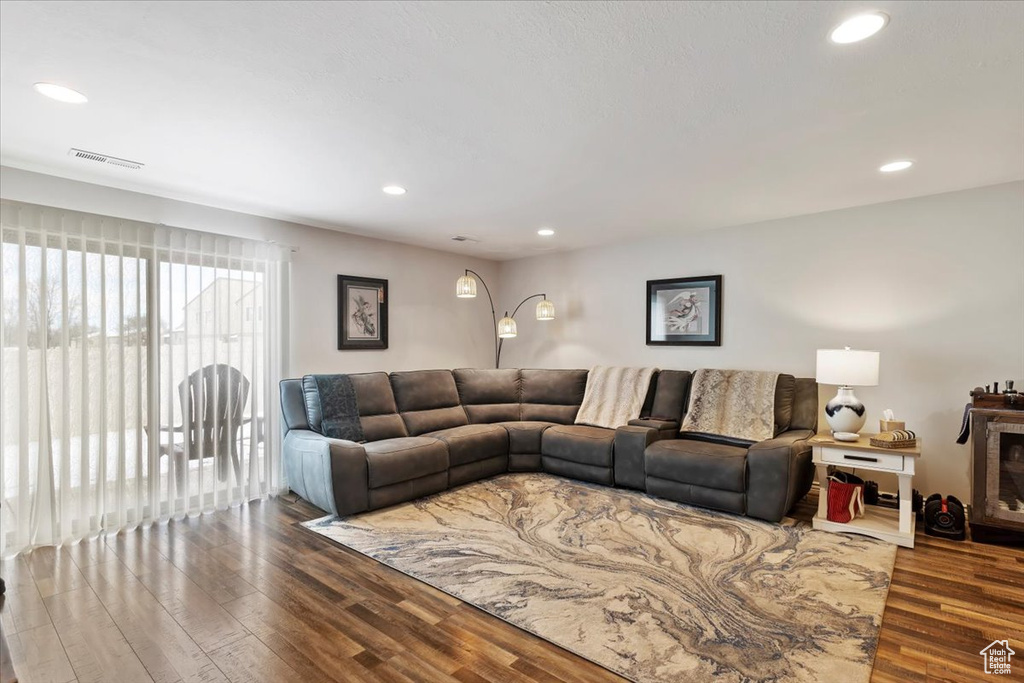 Living room with visible vents, recessed lighting, and wood finished floors