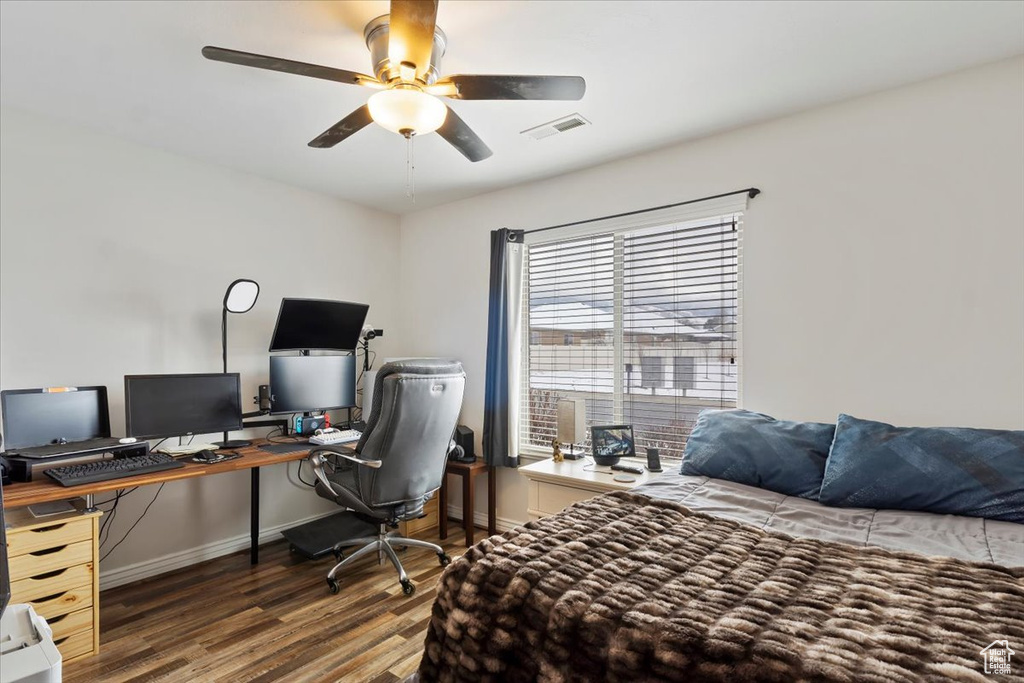 Bedroom with visible vents, ceiling fan, baseboards, and wood finished floors