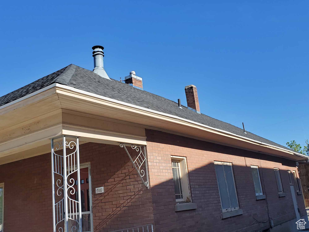 View of home's exterior featuring brick siding and a chimney