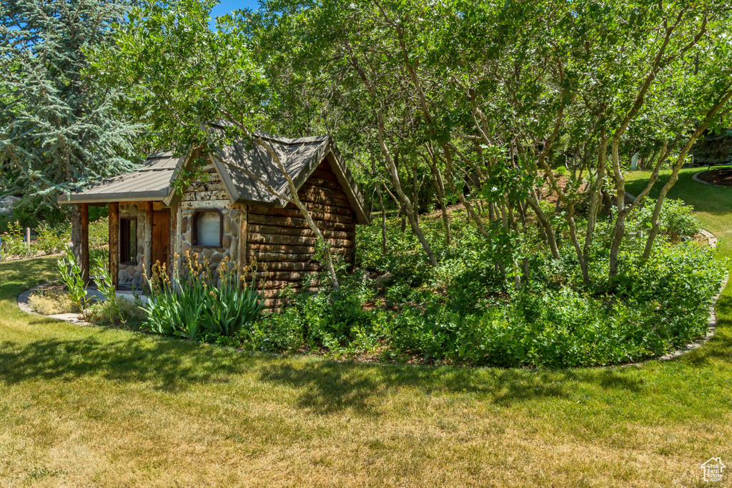 View of grassy yard with an outdoor structure